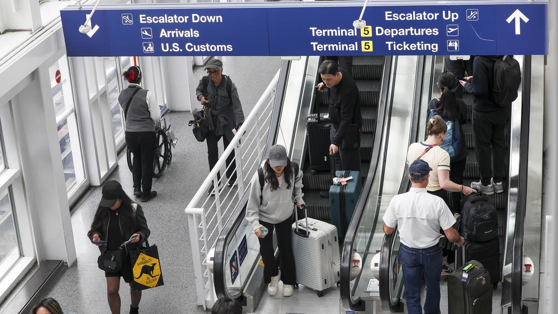 Travelers ride escalators in Terminal 5 at Chicago O'Hare International Airport on April 2, 2026. (Eileen T. Meslar/Chicago Tribune/TNS)