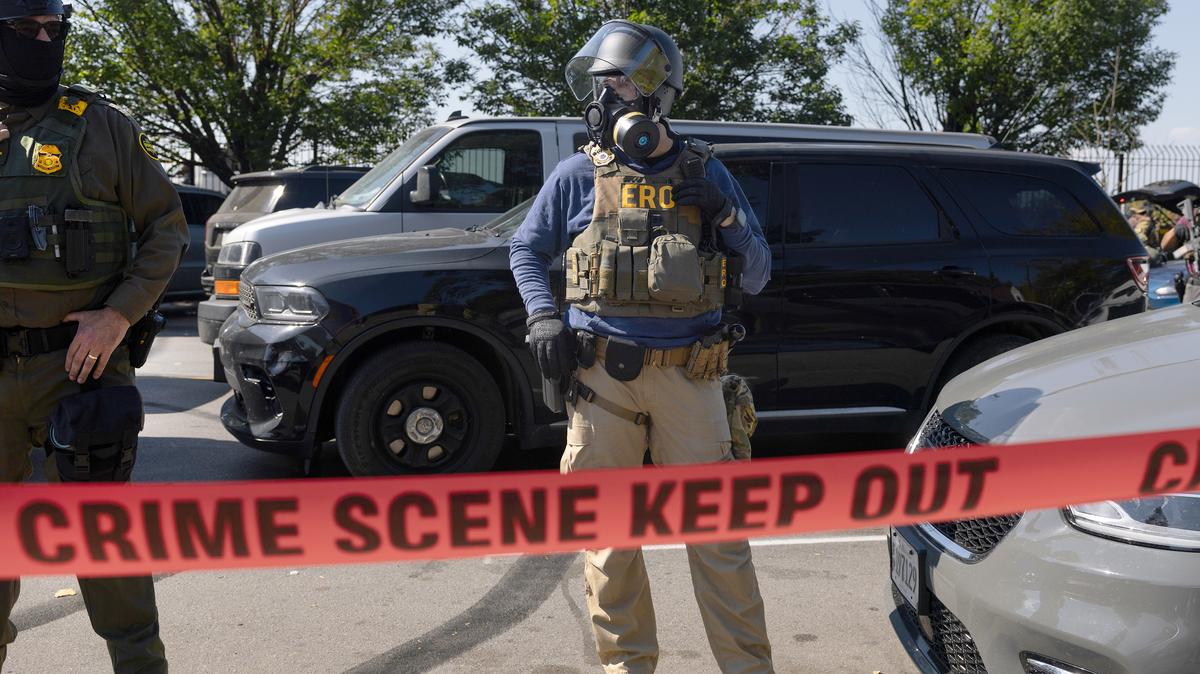 Federal law enforcement agents are confronted by community members and activists for reportedly shooting a woman in the Brighton Park neighborhood on Oct. 4, 2025, in Broadview, Illinois. Residents of the city have become increasingly concerned as Operation Midway Blitz continues in the Chicago area, an operation designed to apprehend and deport undocumented immigrants living in the area. (Scott Olson/Getty Images/TNS)