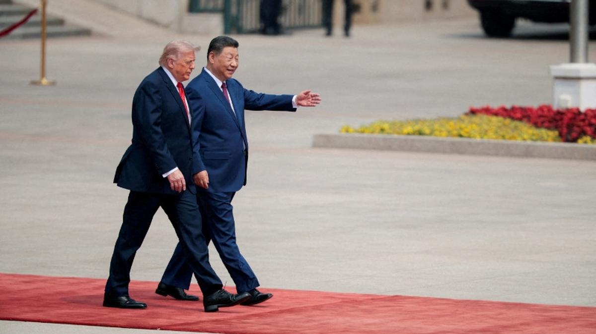 FILE PHOTO: U.S. President Donald Trump walks with Chinese President Xi Jinping upon arrival at the Great Hall of the People in Beijing, China, May 14, 2026. REUTERS/Evan Vucci/File Photo