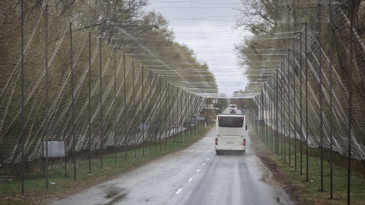 A bus drives on a road covered with anti-drone net near the Chornobyl Nuclear Power Plant, amid Russia's attack on Ukraine, in Kyiv region, Ukraine April 26, 2026.