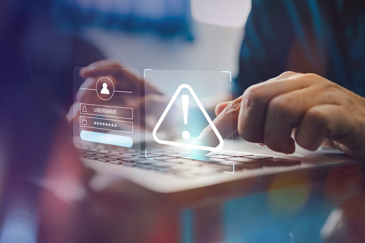  Stock image: a person uses a laptop and a malware screen with phishing email, hack password and personal data. 