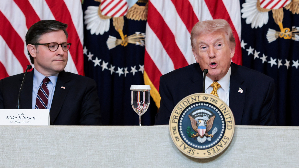 U.S. Speaker of the House Mike Johnson (R-LA) listens to U.S. President Donald Trump speaking during a lunch with the Kennedy Center board members in the East Room of the White House in Washington, D.C., U.S., March 16, 2026. REUTERS/Jonathan Ernst/File Photo