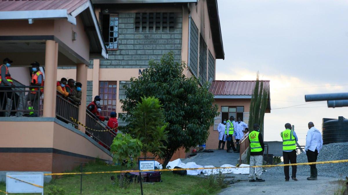 The bodies of the victims of a overnight fire at Utumishi Girls Academy are moved outside the burned dormitory in Gilgil, 77 miles northwest of Nairobi, Kenya, on Thursday. At least 16 students were killed in a fire in the school dorm. On Friday, eight girls were arrested on suspicion of arson. Photo by Stringer/EPA