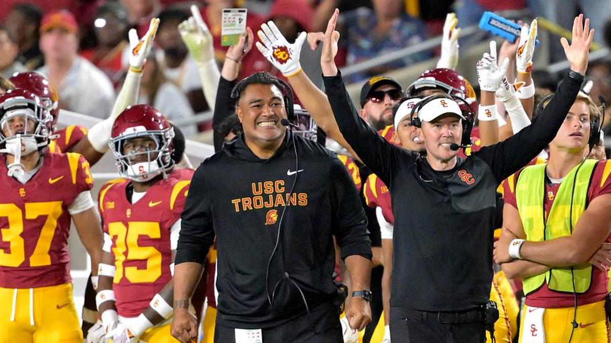  Oct 11, 2025; Los Angeles, California, USA; USC Trojans head coach Lincoln Riley (wearing white visor) celebrates along with defensive end coach Shaun Nua after kicker Ryon Sayeri (48) hit a 54-yard field goal in the second half against the Michigan Wolverines at United Airlines Field at the Los Angeles Memorial Coliseum. Mandatory Credit: Jayne Kamin-Oncea-Imagn Images | Jayne Kamin-Oncea-Imagn Images 