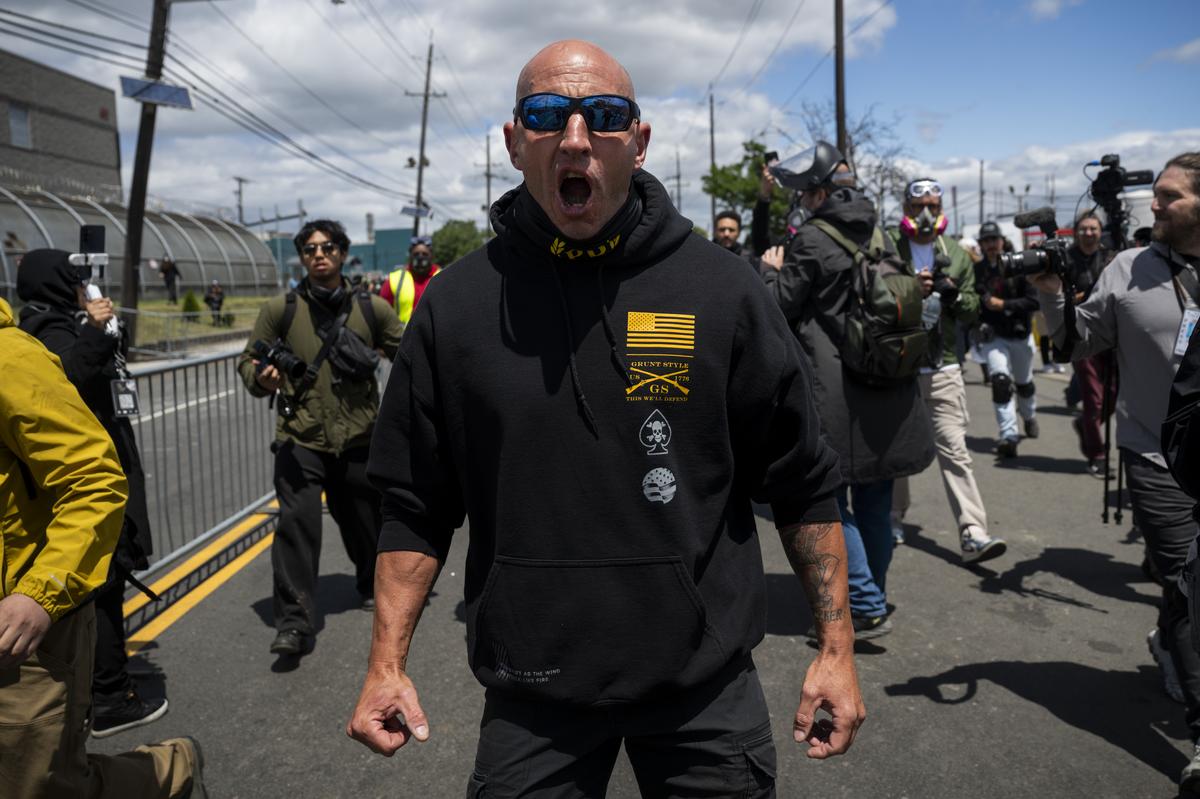 A member of the far-right Proud Boys group walks with other counterprotesters to confront anti-ICE demonstrators outside Delaney Hall, a federal detention facility in Newark, N.J. on Saturday, May 30, 2026. Clashes between protesters and armed federal agents here have flared off and on since the Memorial Day weekend; on Friday, federal officials left the area outside the detention center so that the state police could assume control. (Vincent Alban/The New York Times)