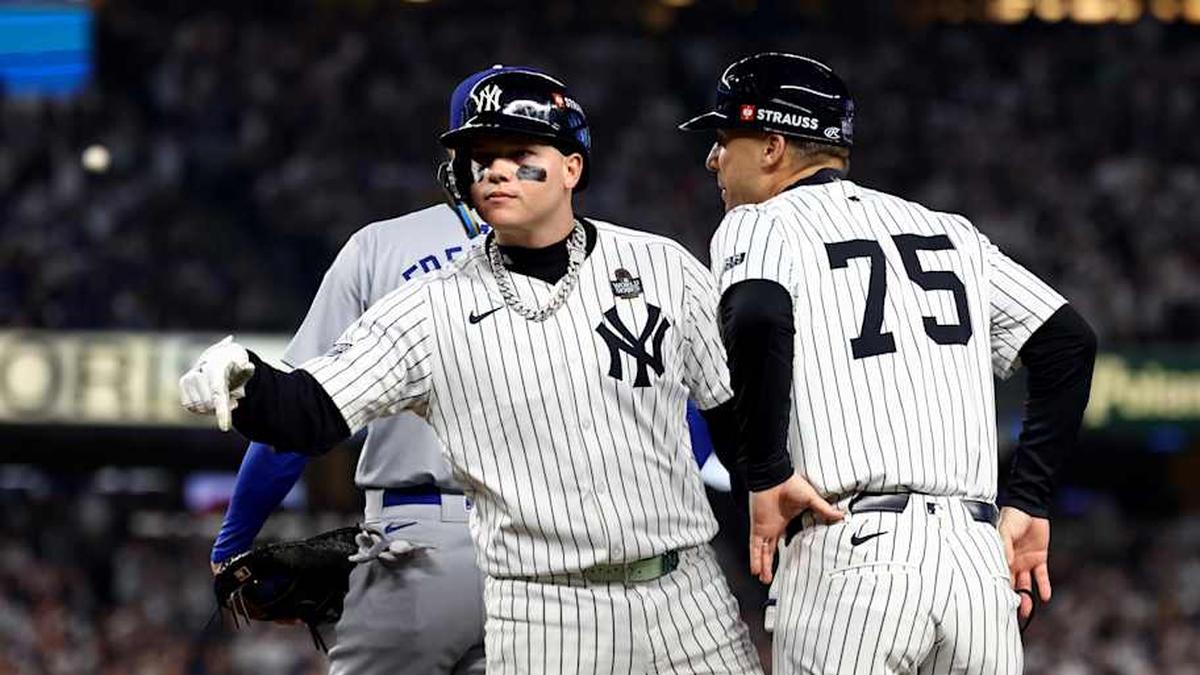  New York Yankees outfielder Alex Verdugo (24) celebrates with first base coach Travis Chapman (75) after hitting a RBI single during the second inning against the Los Angeles Dodgers in game five of the 2024 MLB World Series at Yankee Stadium. | Vincent Carchietta-Imagn Images 