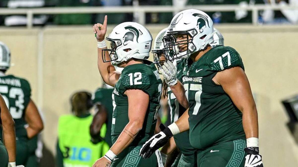  Michigan State's Katin Houser, left, celebrates his rushing touchdown against Washington during the fourth quarter on Saturday, Sept. 16, 2023, at Spartan Stadium in East Lansing. | USA TODAY Network via Reuters Connect 