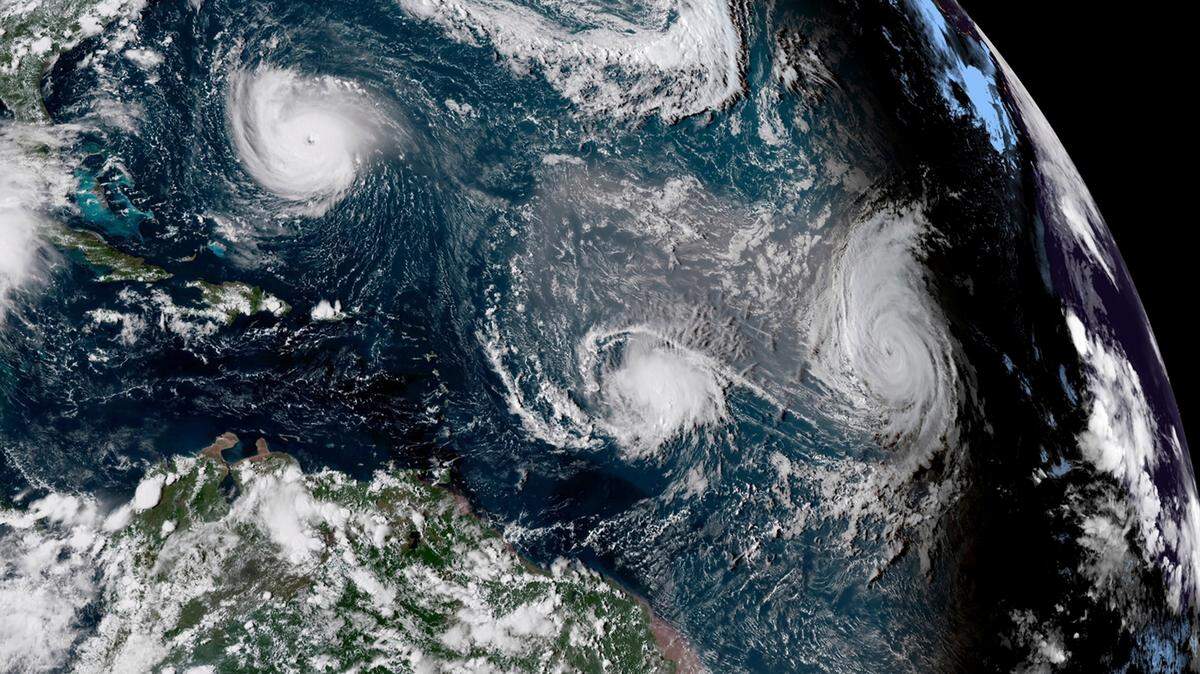 A satellite image provided by NOAA shows Tropical Storm Florence, upper left, in the Atlantic Ocean on Sept. 11, 2018. NOAA will soon stop providing data from satellites that have been helping hurricane forecasters do their jobs for decades.