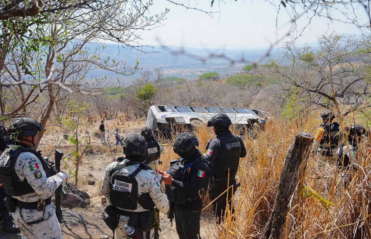 Members of the security forces stand near the site where a tourist bus overturned, killing several people and injuring others near the town of Amatlan de Canas, in the western state of Nayarit, Mexico, May 1, 2026. REUTERS/Christian Ruano