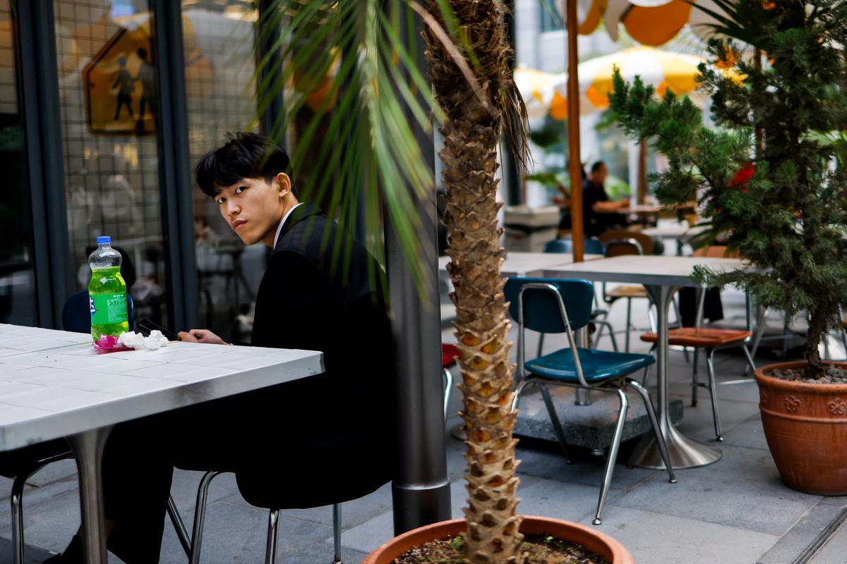 A man looks on as he sits in a street cafe in Beijing, China, May 9, 2026. REUTERS/Maxim Shemetov
