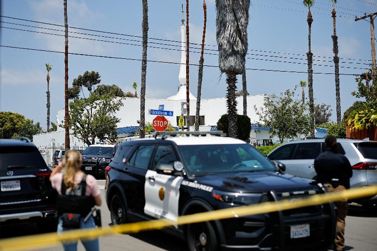 Emergency workers respond at the scene of a reported active shooter situation at the Islamic Center, with yellow tape to cordon the area in the foreground, in San Diego, California, U.S., May 18, 2026.  REUTERS/Mike Blake