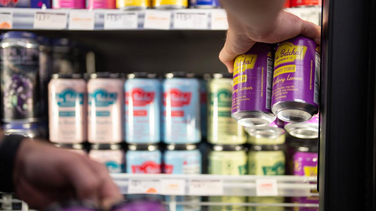 A sales representative restocks THC-infused beverages in a cooler at Elevated Beer Wine & Spirits in Minneapolis. (Alex Kormann/The Minnesota Star Tribune/TNS)