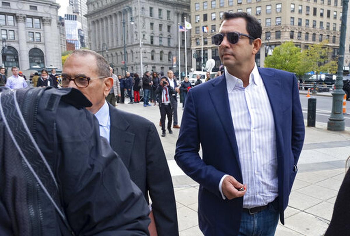 Andrey Kukushkin, right, leaves federal court Oct. 17, 2019, in New York. Kukushkin pleaded not guilty Thursday to conspiring with associates of Rudy Giuliani to make illegal campaign contributions. Kukushkin is an officer in a Sacramento cannabis dispensary operated by a local businessman who controls a considerable share of the Sacramento pot business, records show.