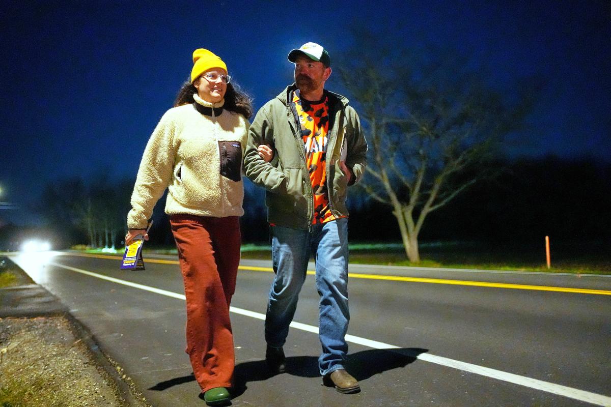  Graham Platner and Amy Gertner walk on the shoulder of the road while canvassing for a citizen’s initiative on Election Day, Tuesday, November 4, 2025, in Ellsworth, Maine. 
