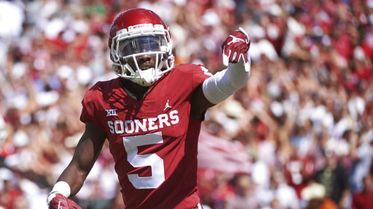 In this Oct. 6, 2018, file photo, Oklahoma wide receiver Marquise Brown (5) gestures “horns down” as he celebrates after scoring a touchdown on a 77-yard reception against Texas in the second half of an NCAA college football game at the Cotton Bowl in Dallas. The Texas-Oklahoma rivalry is never short on bad blood between the Big 12 border states.