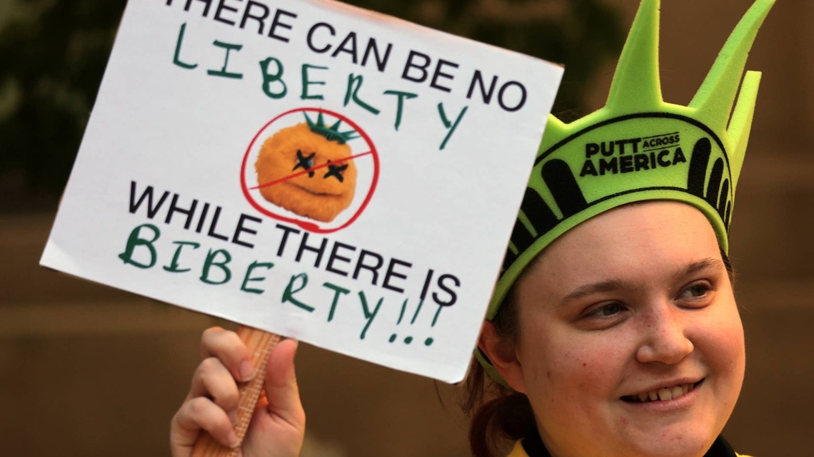 Crowds Gather Outside Liberty Mutual HQ to Demand End to ‘Annoying' Mascot in Fiery Protest 