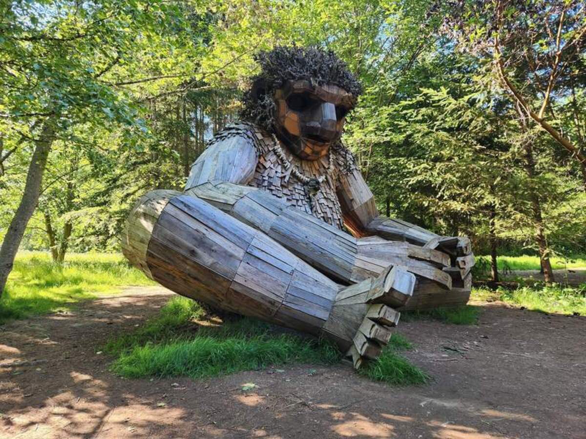  The impressive recycled wood troll installation stands among the forest trees. Photo credit: June Russell-Chamberlin 