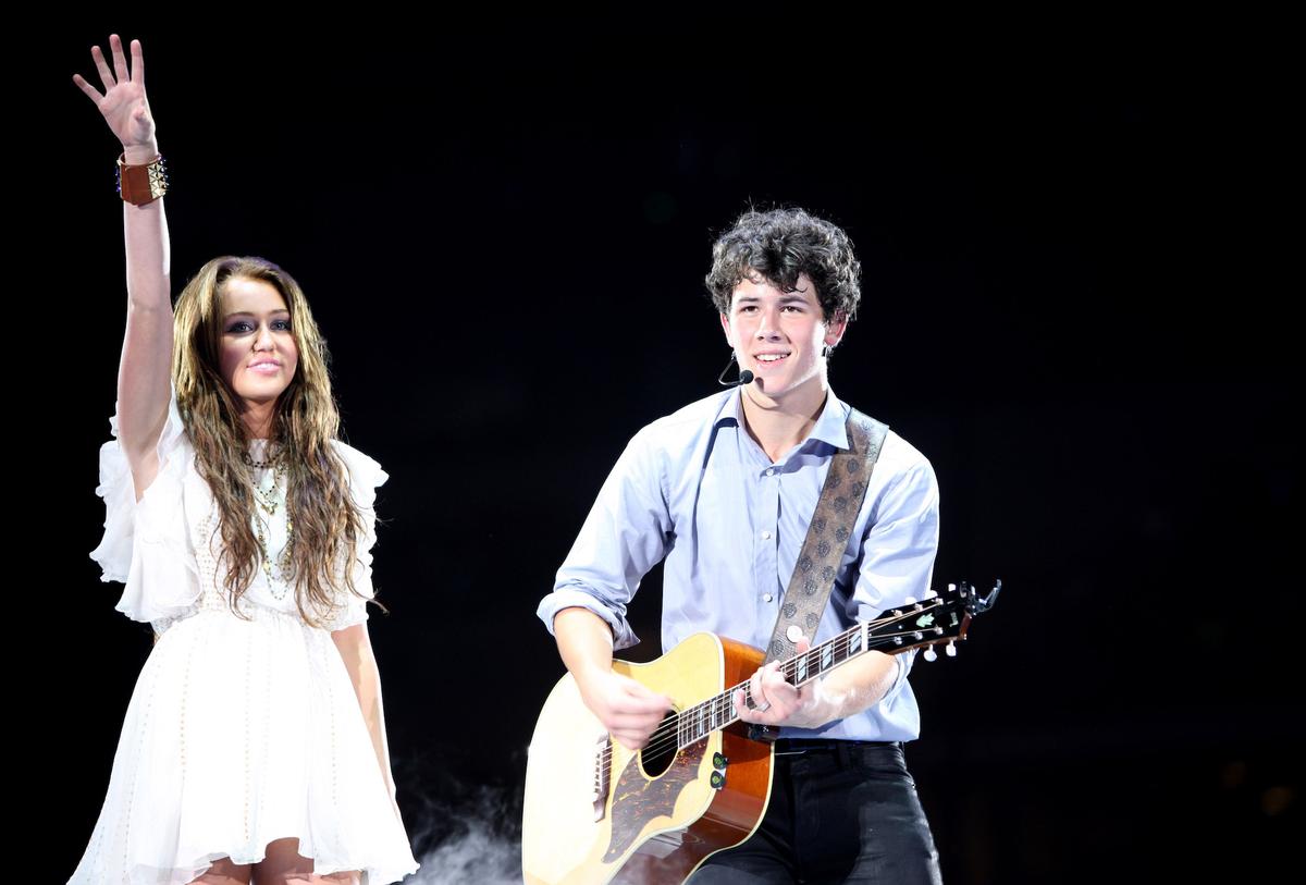 Miley Cyrus and Nick Jonas perform at New Cowboys Stadium on June 20, 2009 in Dallas, Texas.