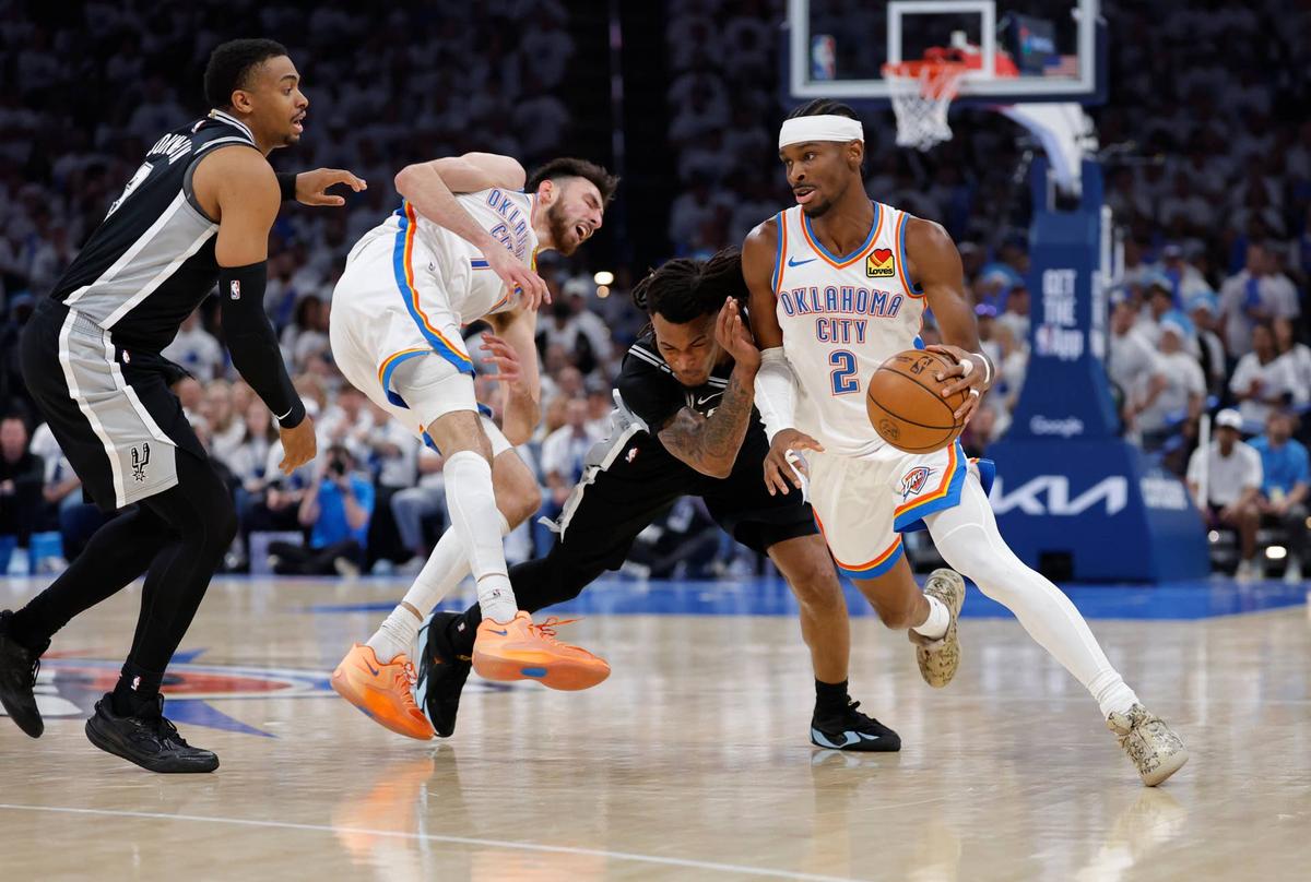  Oklahoma City Thunder guard Shai Gilgeous-Alexander (2) drives past San Antonio Spurs guard Stephon Castle (5) and Oklahoma City Thunder center Chet Holmgren (7) picks in front of San Antonio Spurs forward Keldon Johnson (3). 