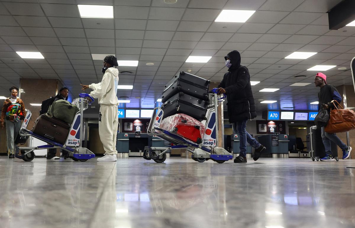 Ghanaians arrive with their luggage at the airport as Ghana repatriates hundreds of its citizens from South Africa following instances of violence against migrants from other sub-Saharan African countries, amid a wave ‌of protests against illegal immigration, at O.R. Tambo International Airport in Kempton Park, South Africa, May 27, 2026. REUTERS/Siphiwe Sibeko