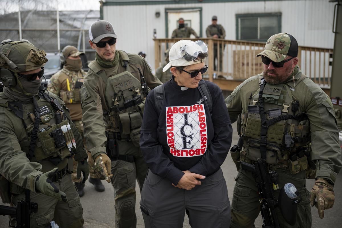 An anti-ICE demonstrator is asked by federal agents to move, outside Delaney Hall, an ICE detention facility in Newark, N.J. on Saturday, May 30, 2026. Clashes between protesters and armed federal agents here have flared off and on since the Memorial Day weekend; on Friday, federal officials left the area outside the detention center so that the state police could assume control. (Vincent Alban/The New York Times)