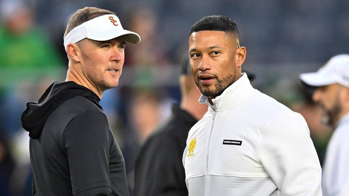  Oct 14, 2023; South Bend, Indiana, USA; USC Trojans head coach Lincoln Riley and Notre Dame Fighting Irish head coach Marcus Freeman chat before the game at Notre Dame Stadium. Mandatory Credit: Matt Cashore-Imagn Images | Matt Cashore-Imagn Images 