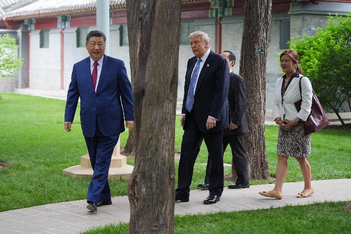 President Donald Trump walks with China’s President Xi Jinping at the Zhongnanhai leadership compound, Friday, May 15, 2026, in Beijing.  Mark Schiefelbein/Pool via REUTERS