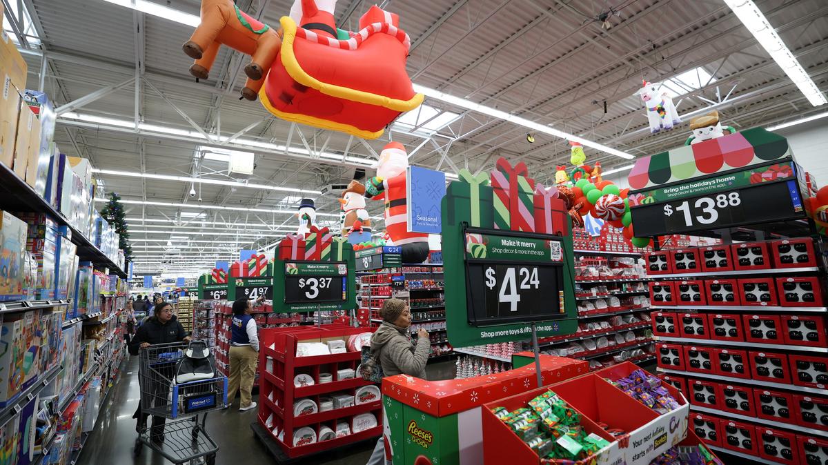 Customers walk through holiday shopping displays at a Walmart Supercenter retail store in North Bergen, New Jersey, U.S., November 21, 2025.  REUTERS/Mike Segar