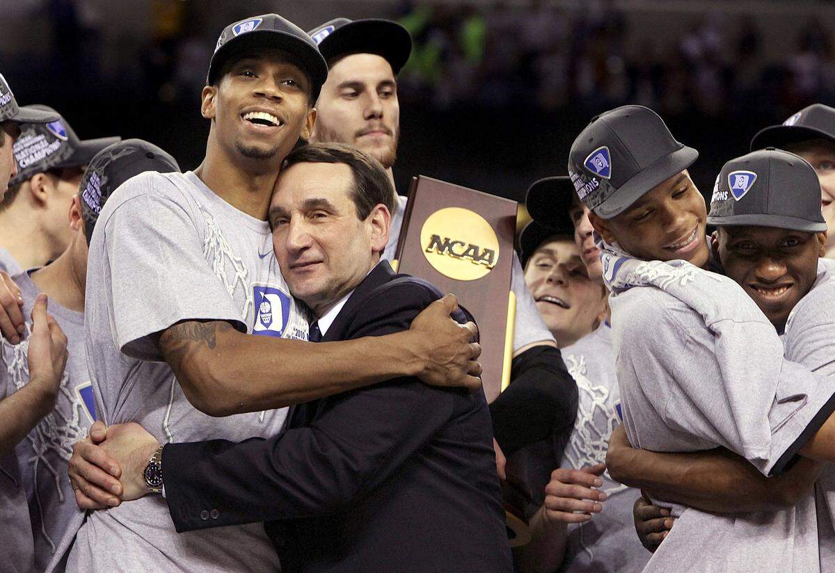 Duke coach Mike Krzyzewski hugs senior forward Lance Thomas while Brian Zoubek clutches the school’s fourth NCAA championship trophy following the 2010 title game in Indianapolis.