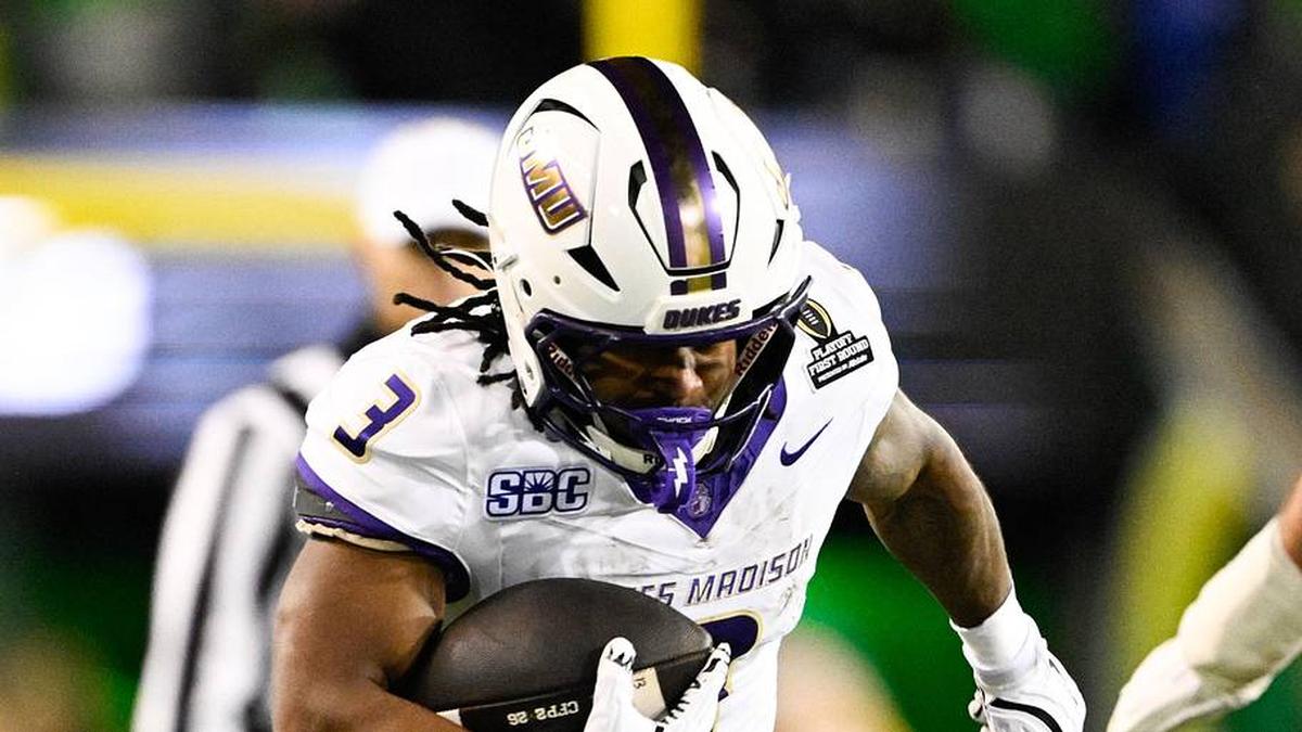  Dec 20, 2025; Eugene, OR, USA; James Madison Dukes running back Wayne Knight (3) rushes as Oregon Ducks defensive back Aaron Flowers (21) defends during the second quarter at Autzen Stadium. Mandatory Credit: Troy Wayrynen-Imagn Images | Troy Wayrynen-Imagn Images 