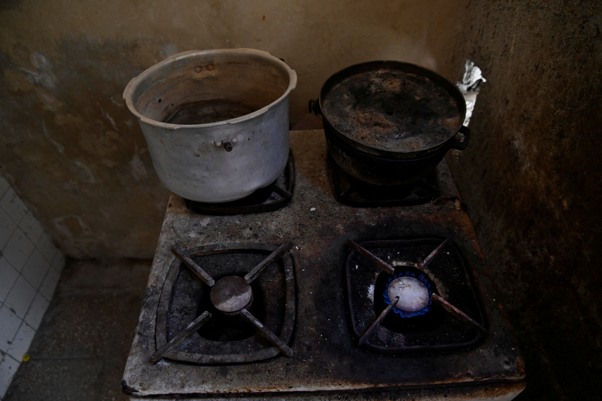A burner on the stove of Sagrado Armando Garcia, 85, a retired government bureaucrat, remains lit because he does not have a lighter, in Havana, Cuba, April 28, 2026. Cuba has struggled for years under U.S. sanctions to provide basic services. Garcia said chronic shortages have forced him to improvise in daily life as cooking fuel and basic supplies run short. "They are leaving us to our fate," he said. REUTERS/Norlys Perez