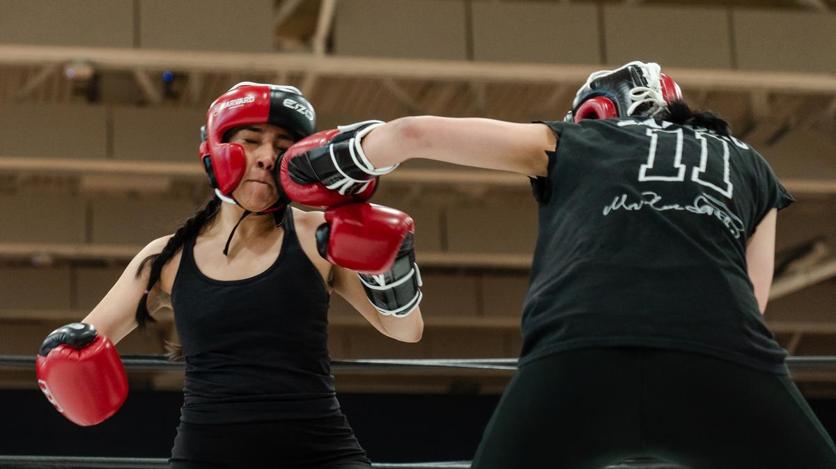Harvard University student Jacqueline Pena Gomez takes a blow from her teammate Muskaan Sandhu while sparring in an exhibition at Babson College in Wellesley, Mass., on April 24, 2026. Boxing clubs at Harvard and other colleges are drawing new members as students look for a real-life connection.