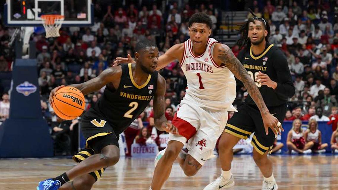  Mar 15, 2026; Nashville, TN, USA; Vanderbilt Commodores guard Duke Miles (2) drives to the basket past Arkansas Razorbacks guard Meleek Thomas (1) during the second half during the men's SEC Conference Tournament Championship at Bridgestone Arena. Mandatory Credit: Steve Roberts-Imagn Images | Steve Roberts-Imagn Images 