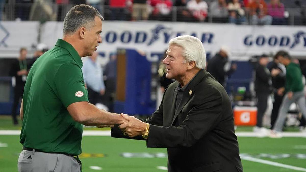  Dec 31, 2025; Arlington, TX, USA; Miami Hurricanes head coach Mario Cristobal greets former Dallas Cowboys head coach Jimmy Johnson before the 2025 Cotton Bowl and quarterfinal game of the College Football Playoff against the Ohio State Buckeyes at AT&T Stadium. Mandatory Credit: Raymond Carlin III-Imagn Images | Raymond Carlin III-Imagn Images 