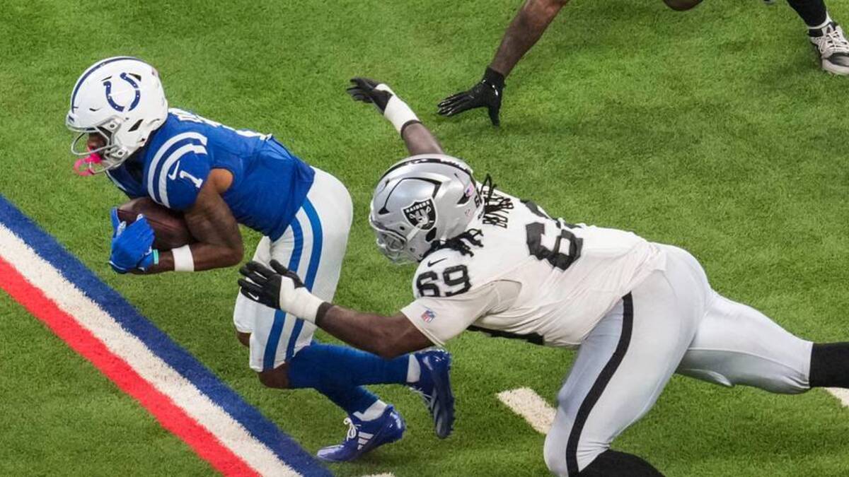  Las Vegas Raiders linebacker Elandon Roberts (52) and Las Vegas Raiders defensive tackle Adam Butler (69) attempt to stop Indianapolis Colts wide receiver Josh Downs (1) on Sunday, Oct. 5, 2025, during a game against the Las Vegas Raiders at Lucas Oil Stadium in Indianapolis. The Indianapolis Colts defeated the Las Vegas Raiders, 40-6. | Grace Smith/IndyStar / USA TODAY NETWORK via Imagn Images 