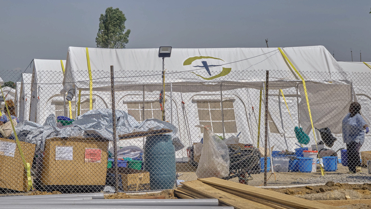 A woman stands by the newly built tents by the Samaritan's Purse International Relief, at the Scott Powell Memorial Ebola Treatment Center, as aid agencies intensify efforts to contain the Ebola outbreak caused by the Bundibugyo virus, in Bunia town, Ituri province, Democratic Republic of Congo, June 11, 2026. REUTERS/Gradel Muyisa Mumbere