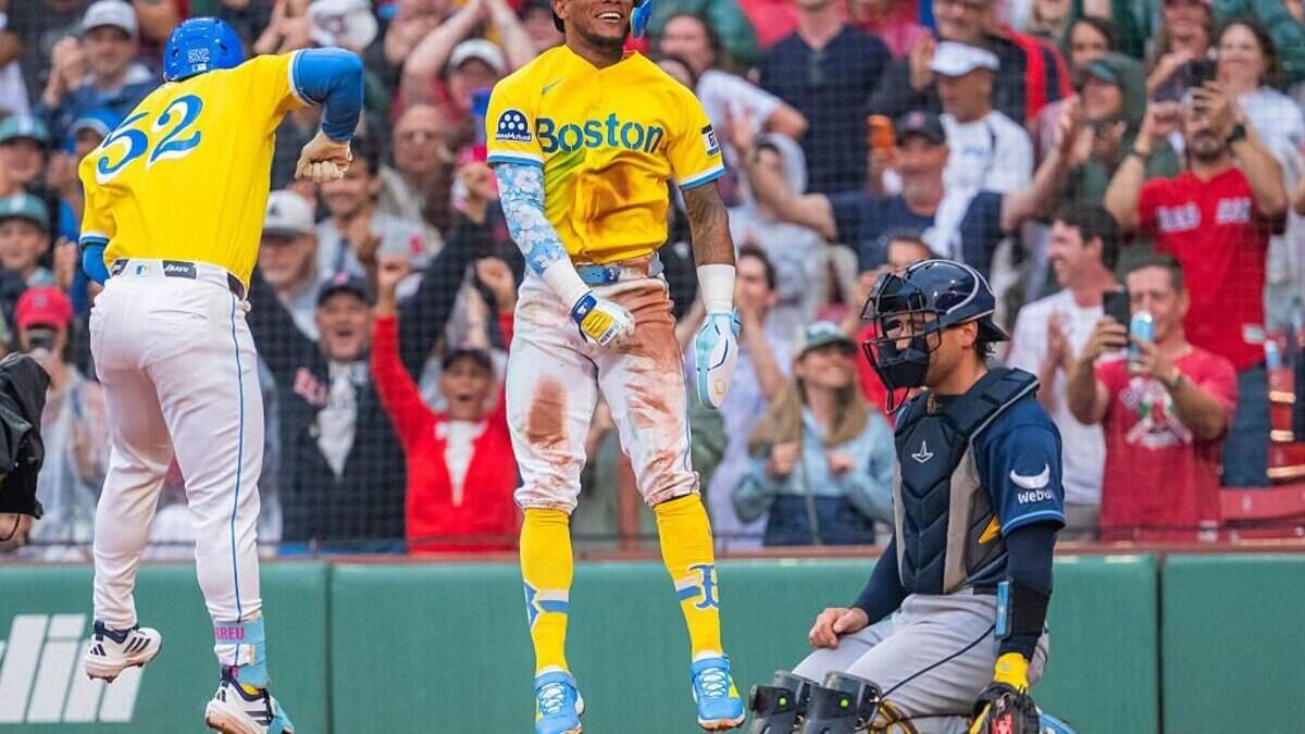 Boston’s Wilyer Abreu, left, and Ceddanne Rafaela celebrate after the Red Sox took the lead in the bottom of the seventh inning of Saturday’s game against the Rays. The Red Sox rallied for a 7-6 victory.