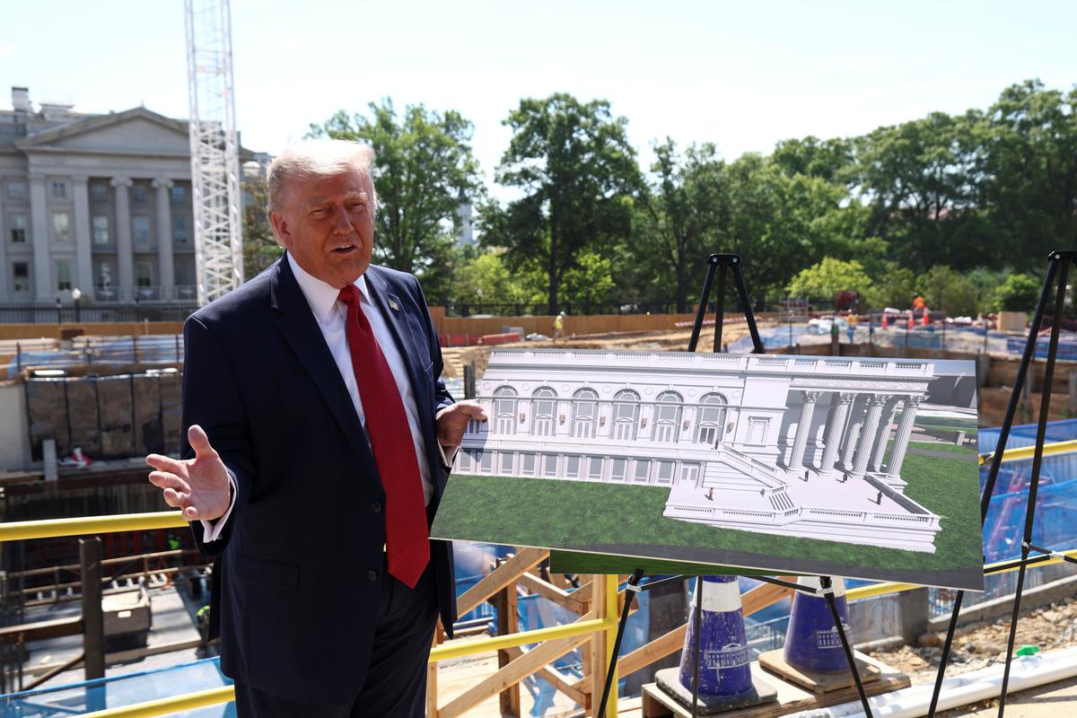 U..S. President Donald Trump shows images of the concept at the site of ongoing construction of the planned White House ballroom in Washington, D.C., U.S., May 19, 2026. REUTERS/Kevin Lamarque
