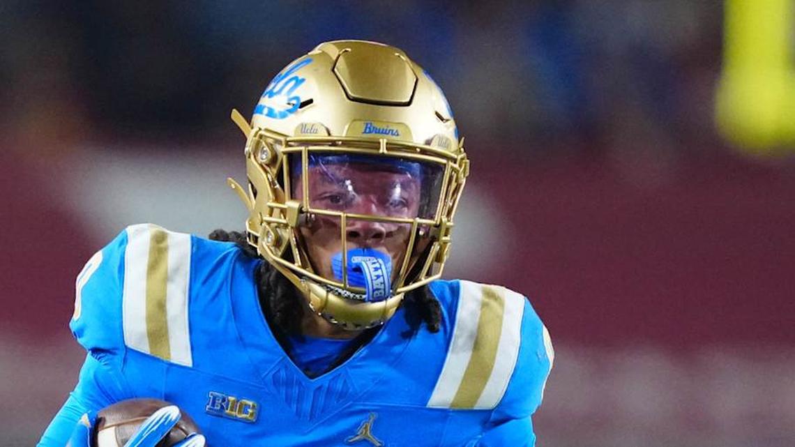  Nov 29, 2025; Los Angeles, California, USA; UCLA Bruins running back Jalen Berger (0) carries the ball against Southern California Trojans safety Kennedy Urlacher (28) in the first half at United Airlines Field at Los Angeles Memorial Coliseum. Mandatory Credit: Kirby Lee-Imagn Images | Kirby Lee-Imagn Images 
