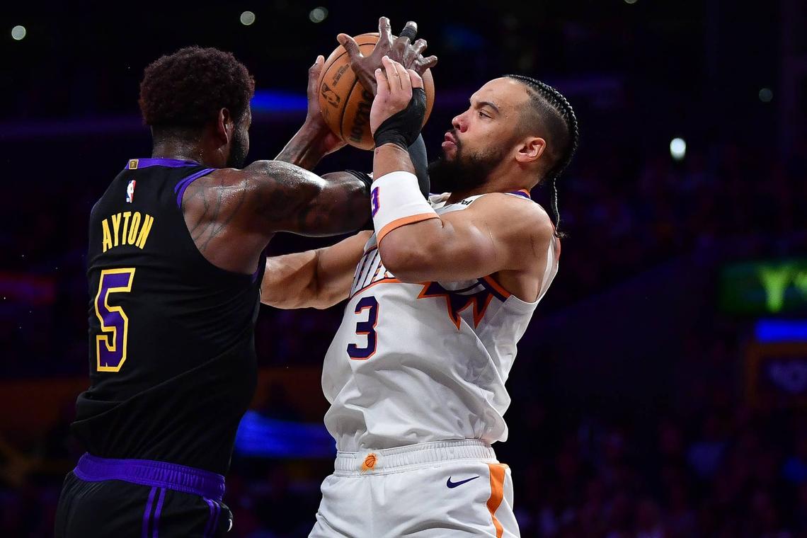  Phoenix Suns forward Dillon Brooks (3) plays for the rebound against Los Angeles Lakers center Deandre Ayton (5) during the first half at Crypto.com Arena. Gary A. Vasquez-Imagn Images