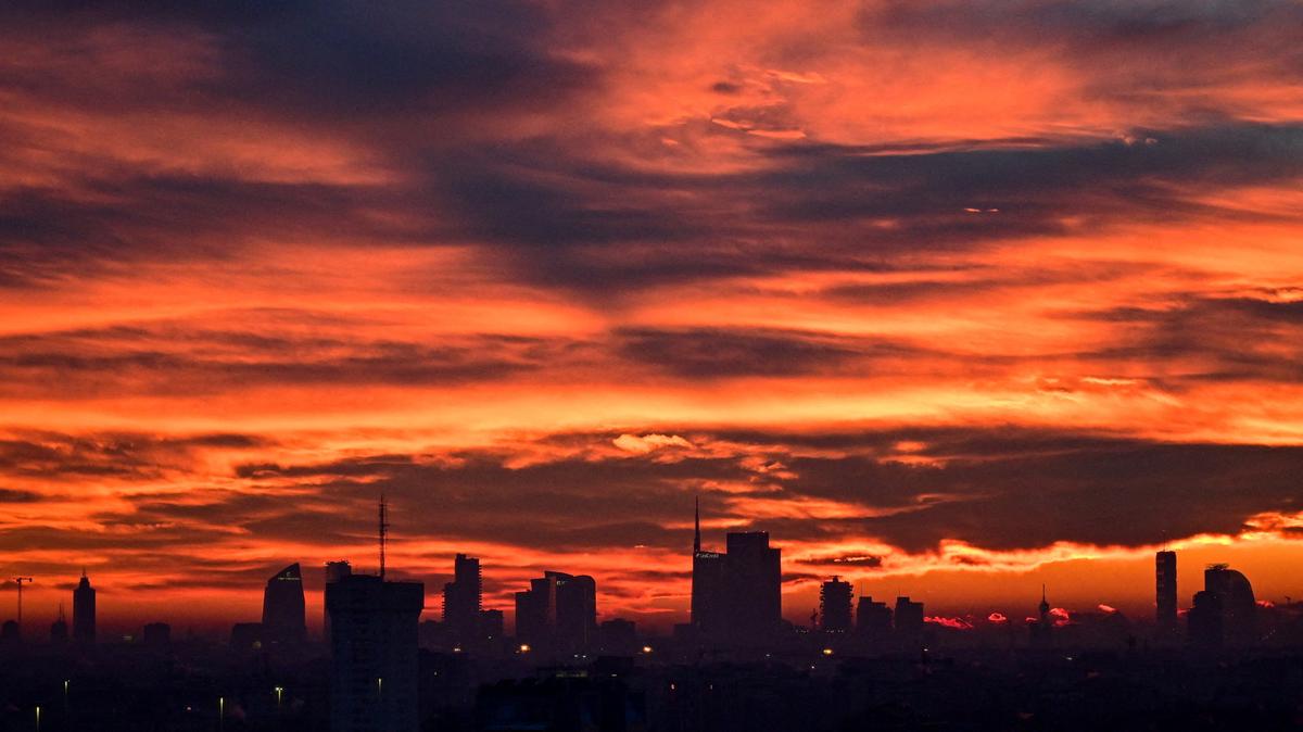 The Milan skyline at sunset with clouds illuminated over the city, in Milan, Italy, January 10, 2026. REUTERS/Daniele Mascolo
