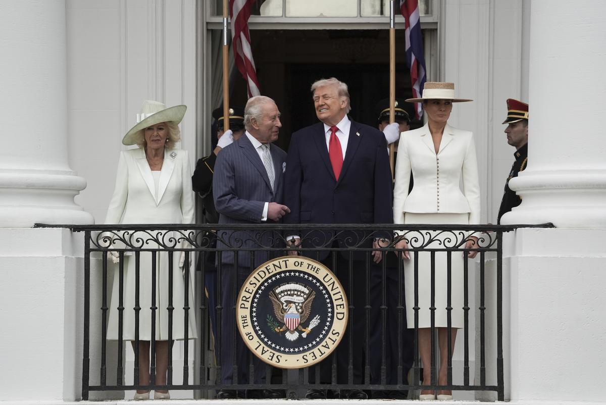 From right: first lady Melania Trump, President Donald Trump, King Charles III, and Queen Camilla watch a pass in review from a balcony of the White House during an arrival ceremony in Washington, on Tuesday, April 28, 2026. (Salwan Georges/The New York Times)