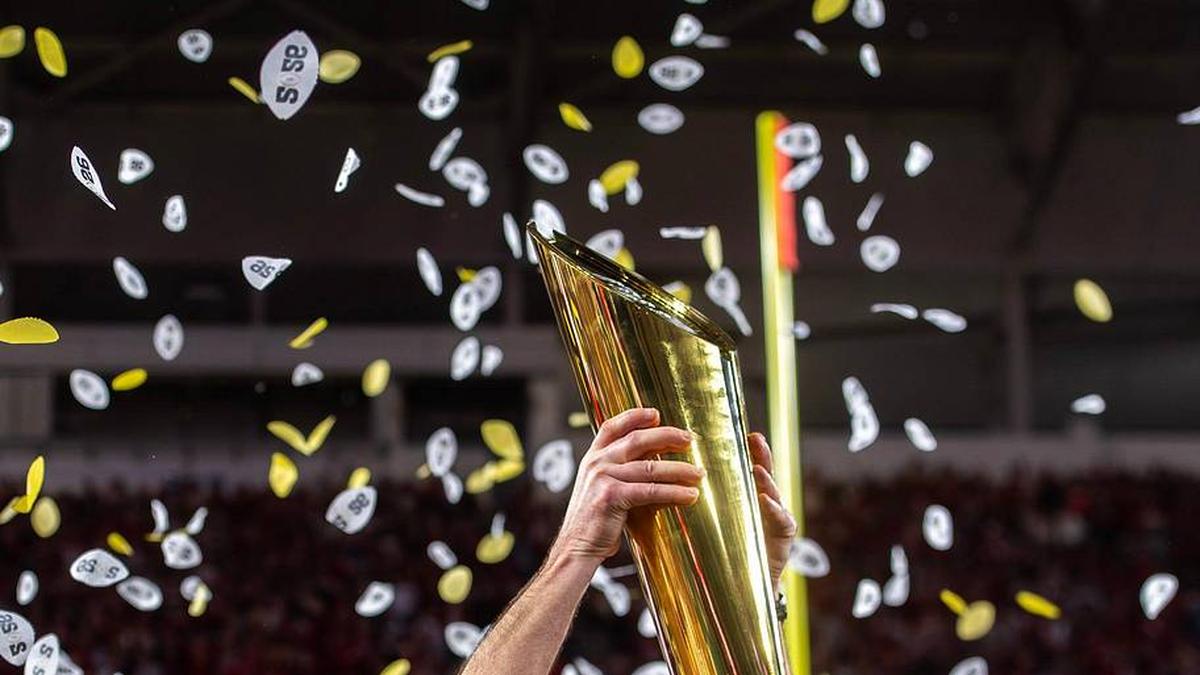  Indiana Head Coach Curt Cignetti lifts the trophy on the podium after the College Football Playoff National Championship college football game at Hard Rock Stadium in Miami Gardens on Monday, Jan. 19, 2026. | Rich Janzaruk/Herald-Times / USA TODAY NETWORK via Imagn Images 