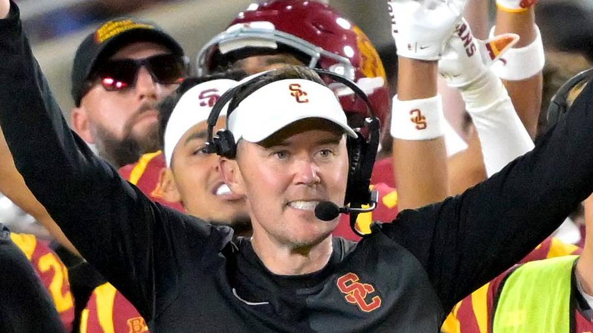  USC Trojans head coach Lincoln Riley and defensive line coach Shaun Nua celebrate on the sideline. | Jayne Kamin-Oncea-Imagn Images 