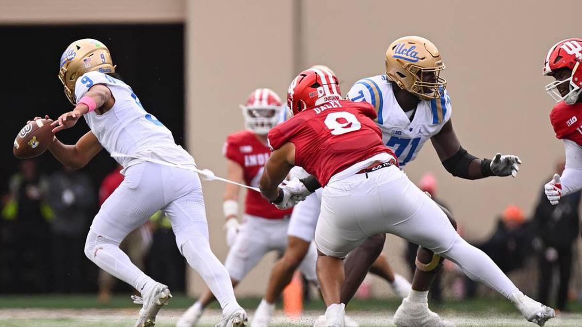  Oct 25, 2025; Bloomington, Indiana, USA; Indiana Hoosiers defensive lineman Stephen Daley (8) pulls the jersey worn by UCLA Bruins quarterback Nico Iamaleava (9) during the second half at Memorial Stadium. Mandatory Credit: Robert Goddin-Imagn Images | Robert Goddin-Imagn Images 
