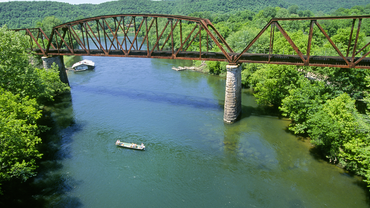 Trout fishermen in a john boat float down the White River in the Ozark National Forest and Ozark Mountains in Arkansas, 1995. (Photo By Buddy Mays/Getty Images).