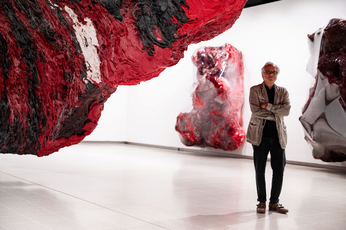 British-Indian sculptor Anish Kapoor poses for a photograph next to his installation 'Mount Moriah at the Gate of the Ghetto' (2022) during the press view for 'Anish Kapoor' at the Hayward Gallery, in London, Britain, June 15, 2026. REUTERS/Chris J. Ratcliffe