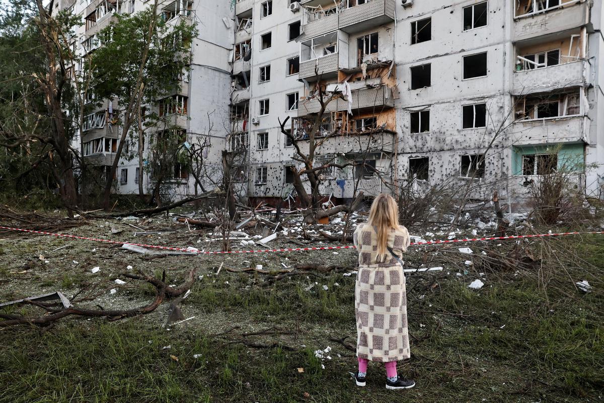 A woman looks at a building damaged during Russian missile and drone strikes, amid Russia's attack on Ukraine, in Kyiv, Ukraine June 2, 2026. REUTERS/Thomas Peter