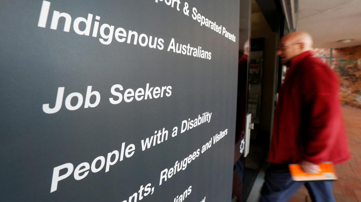 FILE PHOTO: A man walks into a Centrelink office, part of the Australian government's department of human services where job seekers search for employment, in a Sydney suburb, August 7, 2014.  REUTERS/Jason Reed/File Photo