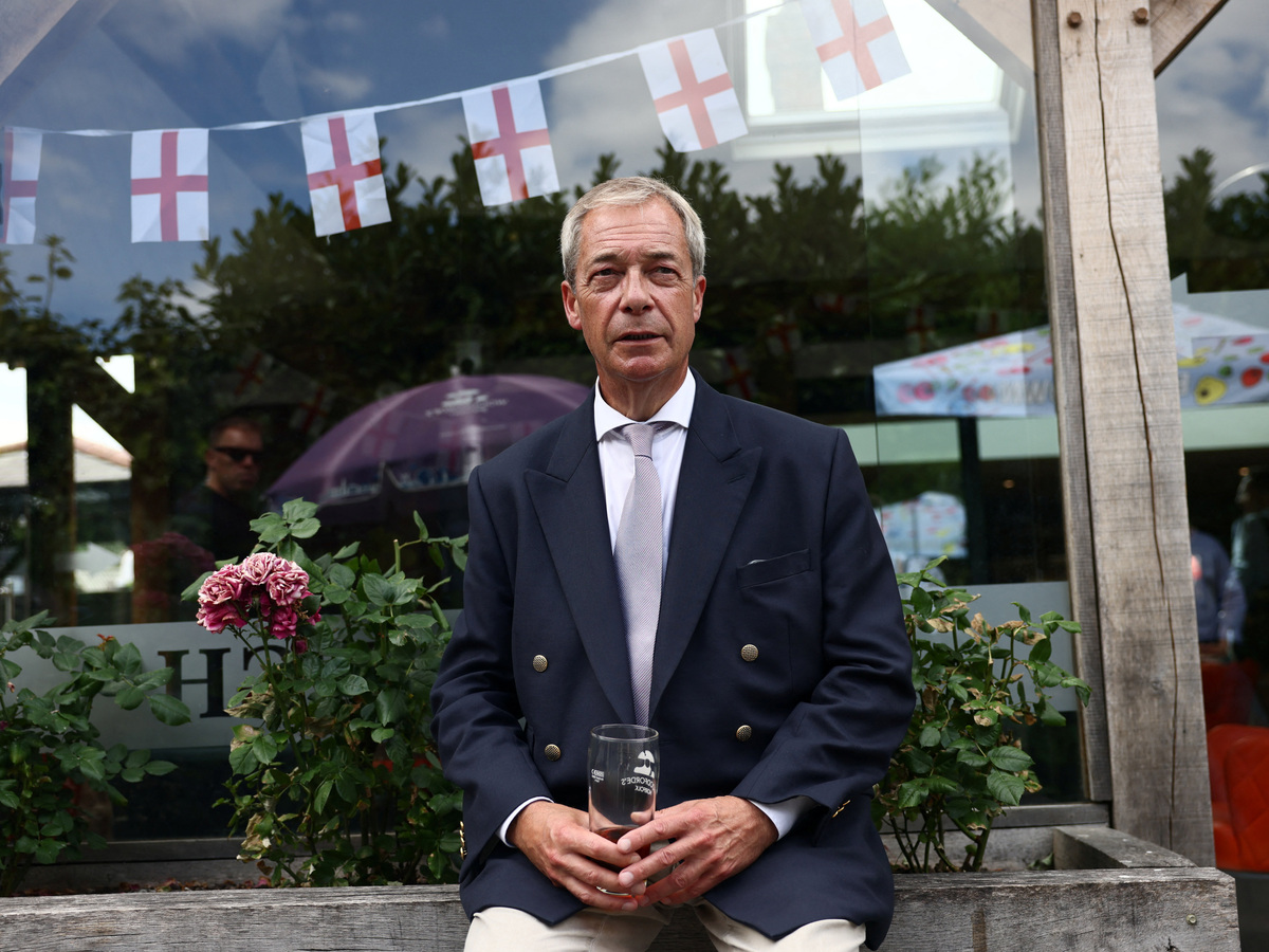 Leader of the Reform UK party Nigel Farage sits at a pub, after he announced on Tuesday that he has resigned as an MP, triggering a by-election in his parliamentary seat, where he intends to stand for re-election, in Great Bentley, Britain, July 8, 2026. REUTERS/Jack Taylor